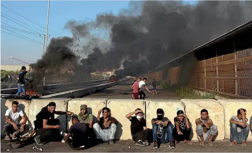  ?? AP ?? Palestinia­n protesters rest behind concrete blocks as others hurl stones at Israeli soldiers during a protest at the entrance of Erez border crossing between Gaza and Israel, in the northern Gaza Strip.