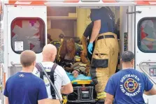  ?? BRANDON DILL/ASSOCIATED PRESS ?? A Walmart employee receives medical attention after a shooting at the store Tuesday in Southaven, Miss. A gunman shot two people and wounded a police officer before he was shot and arrested.