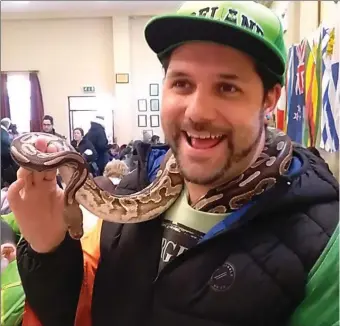  ??  ?? Nathan Kemple and a snake at the Intercultu­ral Event in the Methodist Hall. INSET: Sampling the food.