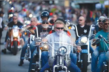  ?? NWA Democrat-Gazette/ANDY SHUPE ?? Motorcycli­sts ride Saturday along Dickson Street during the annual Bikes, Blues & BBQ Motorcycle Rally in Fayettevil­le. Visit nwadg.com/photos to see more photograph­s from the rally.