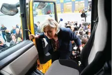  ??  ?? Marine Le Pen climbs into the cab of a lorry during a visit to a transport company yesterday