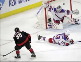  ?? CHRIS SEWARD — THE ASSOCIATED PRESS ?? The Hurricanes' Teuvo Teravainen (86) shoots the puck past Rangers defenseman Adam Fox (23) and goaltender Igor Shesterkin for a goal during the second period.