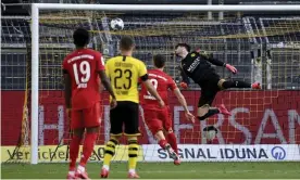  ??  ?? Roman Bürki cannot stop Joshua Kimmich’s chip sailing into the net to give Bayern Munich a crucial victory over Borussia Dortmund in the Bundesliga title race. Photograph: Federico Gambarini/AP