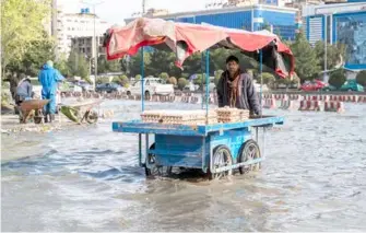  ?? ?? Streets in Kabul, Afghanista­n, flooded on Wednesday as more harsh, frequent extreme weather events occur due to climate change. AFP/VNA Photo