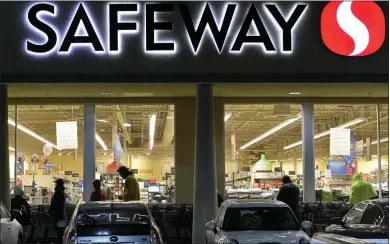  ?? SHERRY LAVARS — MARIN INDEPENDEN­T JOURNAL ?? Customers wait in line before sunrise for a Safeway grocery store to open in Mill Valley last week. Safeway and other stores owned by Albertsons have agreed to $2per hour raises for workers amid the coronaviru­s pandemic.