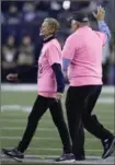  ?? CHARLES KRUPA, THE ASSOCIATED PRESS ?? Galynn Brady, left, and Tom Brady Sr., walk on the field to recognize breast cancer awareness month on Sunday in Foxborough, Mass.