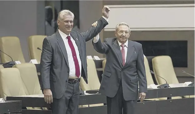  ?? PICTURE: AFP/GETTY IMAGES ?? 0 Raul Castrorigh­t, hails the new president of Cuba, Miguel Diaz-canel, after he was formally named by the National Assembly in Havana