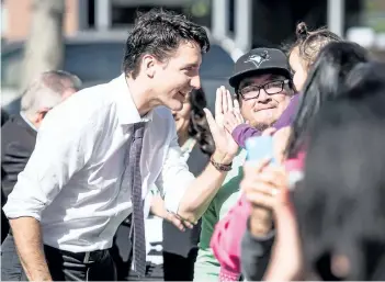  ?? MATT SMITH/ CANADIAN PRESS ?? Prime Minister Justin Trudeau greets people on his way to Oskayak High School in Saskatoon, Sask., on Tuesday.