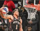  ?? Jason Miller / Getty Images ?? Knicks forward Obi Toppin soared through the air to victory over Juan Toscano-Anderson in the dunk contest.