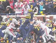  ?? ?? Michigan’s Hassan Haskins ran for 169 yards as the Wolverines averaged 7.2 yards per carry.