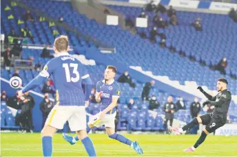  ?? — AFP photos ?? West Ham United’s Said Benrahma (R) shoots to score their first goal during their match against Brighton and Hove Albion at the American Express Community Stadium in Brighton, southern England.