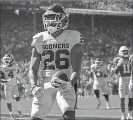  ?? Jeffrey McWhorter Associated Press ?? OKLAHOMA running back Kennedy Brooks runs in for a touchdown during the fourth quarter of the Red River Rivalry. Brooks rushed for 217 yards.