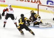  ?? Bruce Bennett / Getty Images ?? The Senators’ Bobby Ryan (9) scores the game-winner against the Penguins’ Marc-Andre Fleury at 4:59 into overtime.