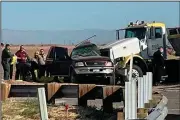  ?? (AP/KYMA) ?? In this image taken from television video, law enforcemen­t officers work Tuesday at the scene of a deadly crash involving a truck and an SUV in Holtville, Calif.