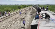  ?? DAX MCDONALD VIA AP ?? An Amtrak passenger train lies on its side after derailing near Mendon, Mo., on Monday. Four people were killed and 150 injured.