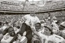  ?? George Widman / Associated Press ?? Dolphins players carry off Don Shula after he registered his 325th career NFL victory in 1993. Shula died Monday at age 90.