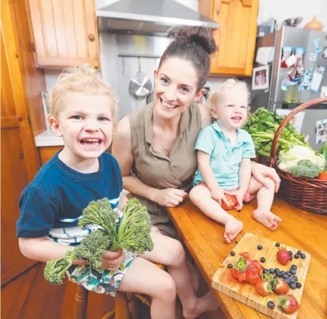  ?? Picture: TARA CROSER ?? PAYING PRICE: Stephanie Mlady at home with sons Oscar, 3, and Louis, 1, with fruit and vegies which are now more expensive due to extreme weather conditions.