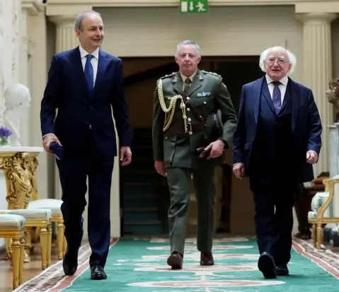  ??  ?? ONWARDS: Taoiseach Micheal Martin (left) and President Michael D Higgins (right) at Aras an Uachtarain, where Martin received his seal of office yesterday afternoon. Photo: Maxwells