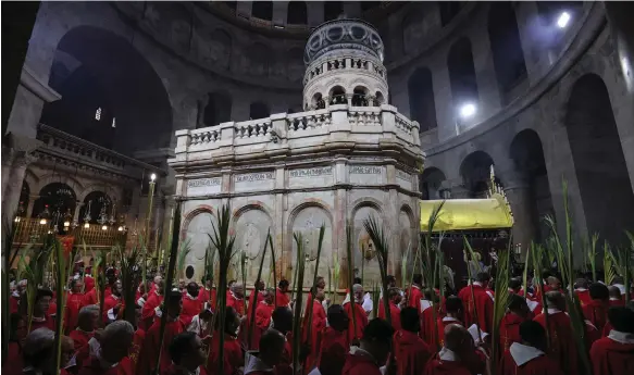  ?? EPA ?? Catholic clerics carry palm branches during the Palm Sunday procession at the Church of the Holy Sepulchre in the Old City of Jerusalem