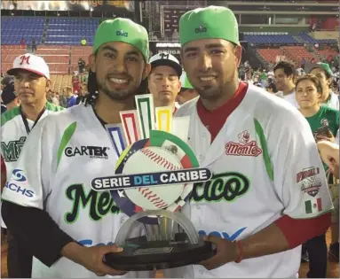  ??  ?? Brawley native Jacob Sanchez (right) poses with a teammate and the Caribbean Series trophy after defeating Venezuela for the title last week. PHOTO COURTESY JACOB SANCHEZ