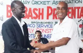  ?? CONTRIBUTE­D PHOTOS ?? Ian Spencer (right), Sandals’ regional public relations manager, accepting the Most Discipline­d Team award from Clinton Clarke, assistant secretary of the Jamaica Cricket Associatio­n, at the Big Bash prize-giving ceremony of the St Mary Cricket Awards...