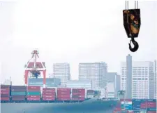  ?? — Reuters ?? A cargo ship is pictured at an industrial port in Tokyo, Japan.