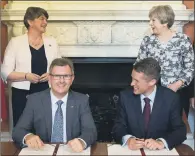  ?? PICTURES: DANIEL LEAL-OLIVAS/PA WIRE. ?? ARRANGEMEN­T: Prime Minister Theresa May with DUP leader Arlene Foster (left) as DUP MP Sir Jeffrey Donaldson (second right) and Parliament­ary Secretary to the Treasury and Chief Whip Gavin Williamson sign the deal yesterday.