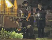  ?? TYLER LARIVIERE/SUN-TIMES ?? Chicago police and Cook County sheriff’s officers investigat­e in the 4600 block of South Laramie on Wednesday night.