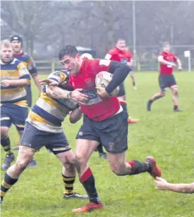  ?? ?? Perfect dozen Ross Tulloch muscles his way through to set-up the Reds’ final try