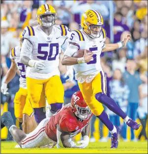  ?? Scott Clause The Associated Press ?? LSU quarterbac­k Jayden Daniels has been a prolific runner for the Tigers this season, rushing for a team-best 619 yards and 10 TDS.