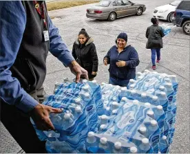  ??  ?? Free bottled water was distribute­d at Kroger locations throughout Montgomery County on Thursday. A large water main break late Wednesday cut water service to much of the county and most of it was restored by Thursday morning.