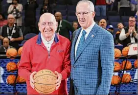  ?? Andy Lyons / Getty Images ?? College basketball broadcaste­r Dick Vitale receives an autographe­d basketball from SEC Commission­er Greg Sankey on Saturday.