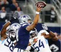  ??  ?? Dallas Cowboys quarterbac­k Dak Prescott throws under pressure from the Tennessee Titans on Monday in Arlington, Texas, where the Titans scored a 28-14 road victory. MICHAEL AINSWORTH/THE ASSOCIATED PRESS