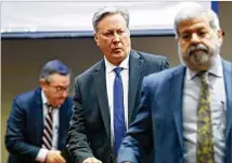  ?? BOB ANDRES / ROBERT.ANDRES@AJC.COM ?? Former police officer Robert Olsen (center) leaves with his attorneys after a brief motions hearing about instructin­g the jury with the Allen charge, an instructio­n meant to encourage juries to continue working until they reach a verdict.