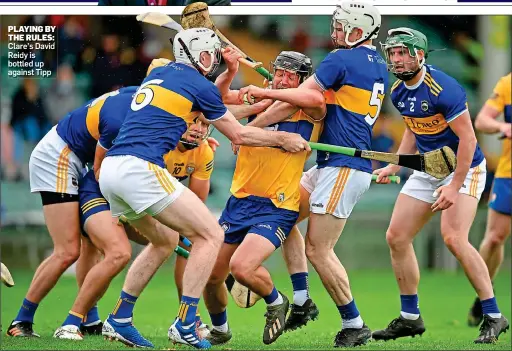  ??  ?? PLAYING BY THE RULES: Clare’s David Reidy is bottled up against Tipp