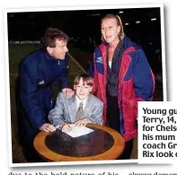  ??  ?? Young gun: Terry, 14, signs for Chelsea as his mum and coach Graham Rix look on