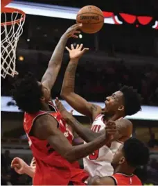  ?? MATT MARTON/THE ASSOCIATED PRESS ?? Raptor Lucas Nogueira, a first-round pick in 2013, denies Denzel Valentine of the Bulls in pre-season action. The teams meet again on opening night.