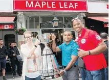  ?? JIM ROSS/CFL ?? Master Seaman Clarisa Smallwood and Master Seaman Kyaw San Myint with Henry Burris in London, England on Friday, where the former Ottawa Redblacks QB surprised Canadian Armed Forces members.