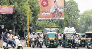  ?? ?? Vehicles move past an election campaign boarding of the BJP featuring their leader and India’s Prime Minister Narendra Modi, Varanasi, India, April 13, 2024.