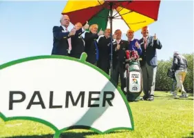  ?? THE ASSOCIATED PRESS ?? Arnold Palmer Invitation­al officials pose for a photo with the late Palmer’s golf bag on Wednesday morning at Bay Hill Club and Lodge in Orlando, Fla.