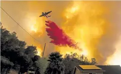  ?? Noah Berger, The Associated Press ?? An air tanker drops retardant as the LNU Lightning Complex fires tear through the Spanish Flat community in unincorpor­ated Napa County, Calif. on Aug. 18.