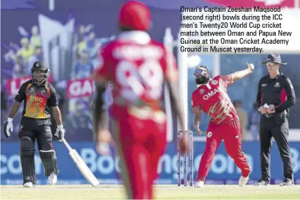  ?? ?? Oman’s Captain Zeeshan Maqsood (second right) bowls during the ICC men’s Twenty20 World Cup cricket match between Oman and Papua New Guinea at the Oman Cricket Academy Ground in Muscat yesterday.