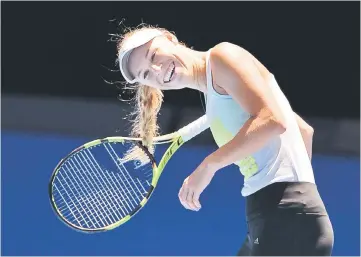  ??  ?? Caroline Wozniacki of Denmark laughs as her hair is caught in the racquet during a practice session ahead of the Australian Open tennis tournament. — Reuters photo