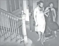  ??  ?? DIRTY DEVILS: A surveillan­ce camera catches two of at least three culprits in the act at the Bronx house of worship.