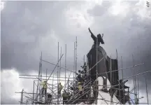  ??  ?? WORKERS DISMANTLE the scaffoldin­g around the People Power monument after cleaning and polishing on Feb. 18, ahead of the 32nd People Power Revolution anniversar­y on Feb. 25.