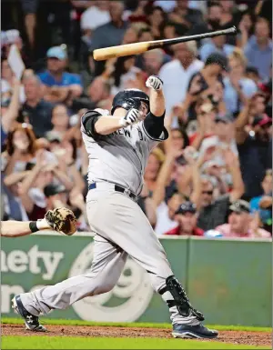  ?? STEVEN SENNE/AP PHOTO ?? Brian McCann of the New York Yankees lets go of the bat after swinging at a pitch in the seventh inning of Monday’s game against the Boston Red Sox at Fenway Park. The Red Sox stranded 14 Yankee baserunner­s and held on for a 4-3 victory.