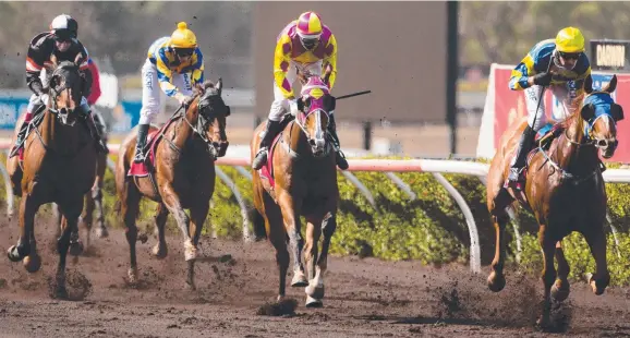  ?? Picture: GLENN CAMPBELL ?? The David Bates-trained five-year-old gelding He’s Our Woody (right), with Paul Shiers in the saddle, takes out the Asian Food Service 0-76 Handicap (1200m) at Fannie Bay yesterday from Poet’s Choice and Arctic Song