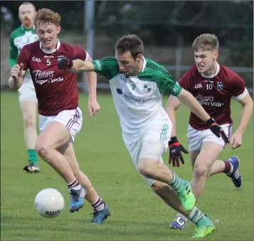  ??  ?? Robbie Barron of St. James’ is chased by St. Martin’s duo Aaron Maddock and Jake Firman in their Tom Doyle Supplies SFC clash in Taghmon on Friday.