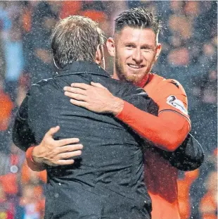  ??  ?? A hug from the manager for ‘outstandin­g Callum Butcher.