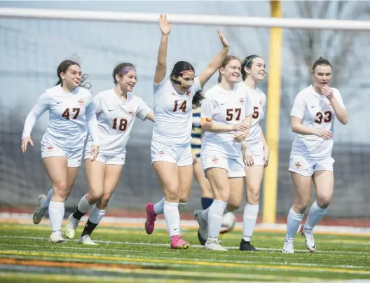  ?? VINCENT D. JOHNSON/DAILY SOUTHTOWN ?? Lincoln-Way West’s Jaiden Hughes, with arms raised, runs toward her teammates after scoring the goal in overtime against Lemont during a Windy City Ram Classic quarterfin­al Saturday in New Lenox.